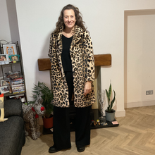 Load image into Gallery viewer, Women’s animal print faux fur coat with flattering fit, styled for elegant wear
